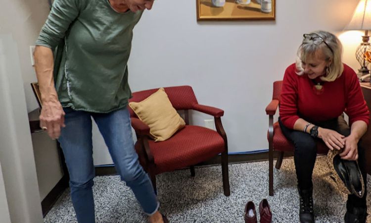 Trying on shoes at Wilson County Thrift Store